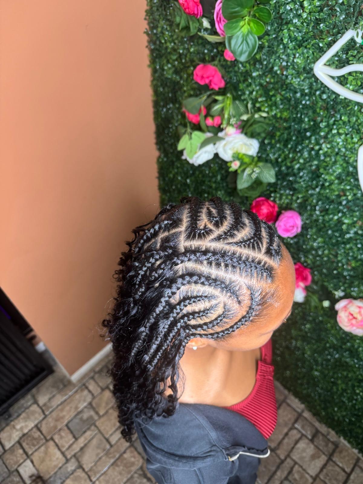 Intricate tribal braid design with curls at Braids by estal